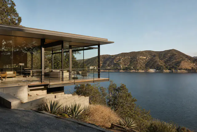 The steel-and-glass pavilion cantilevered over the hillside, the reservoir below.